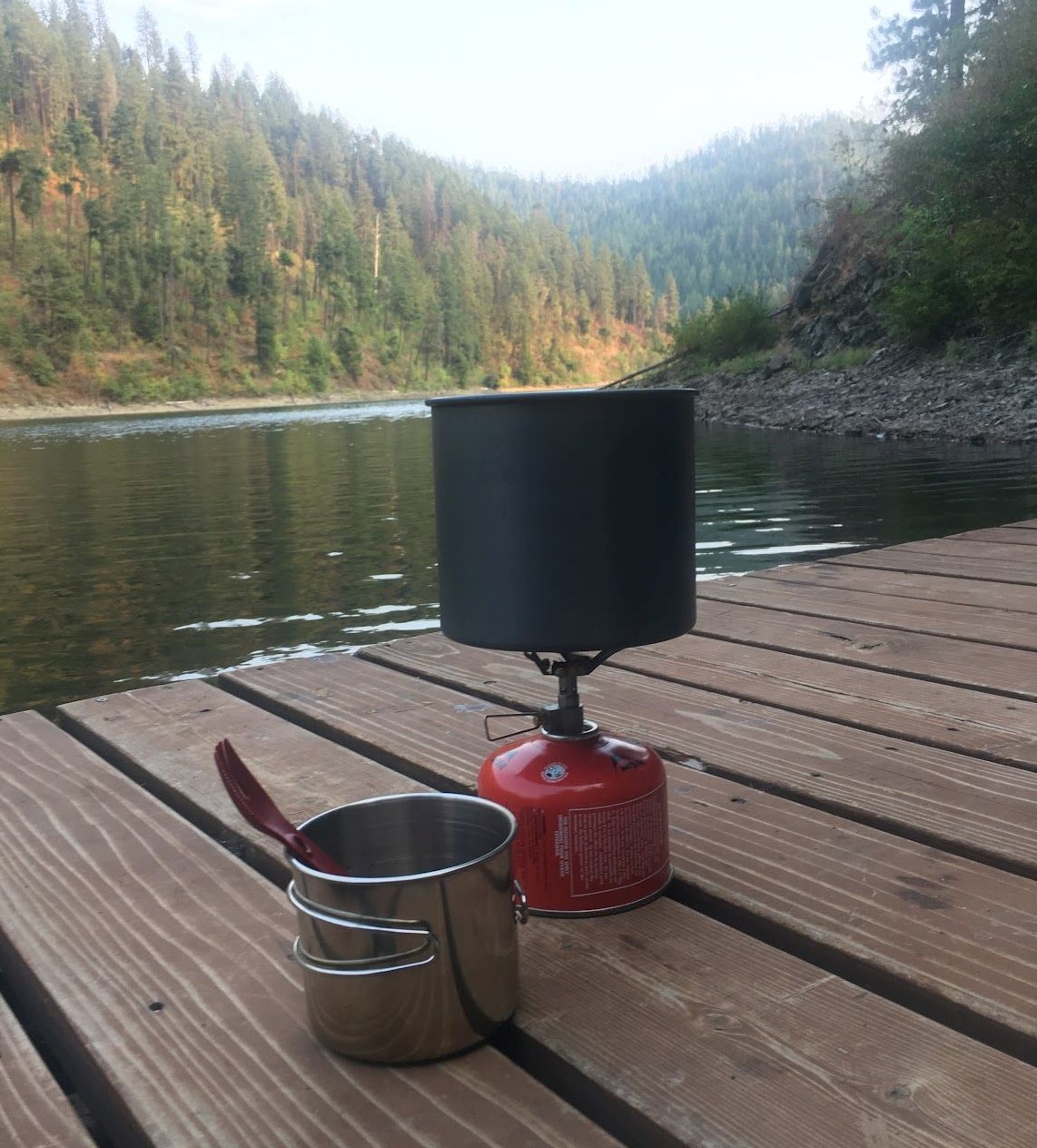 Preparing a backpacking meal by the lake