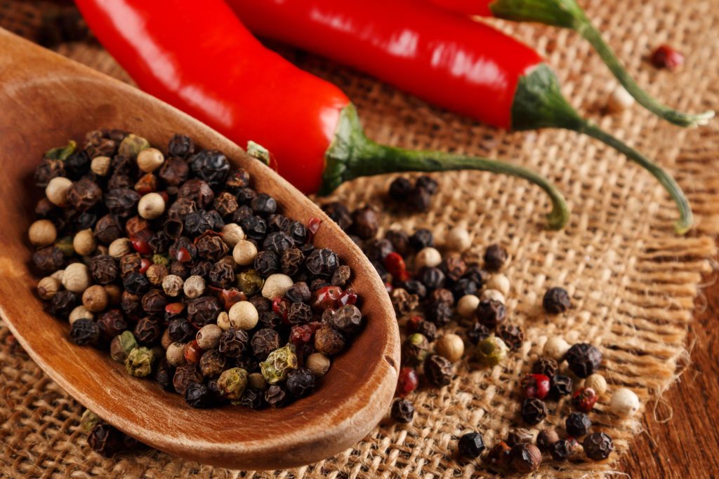 Black peppercorns accompany a spicy chili.